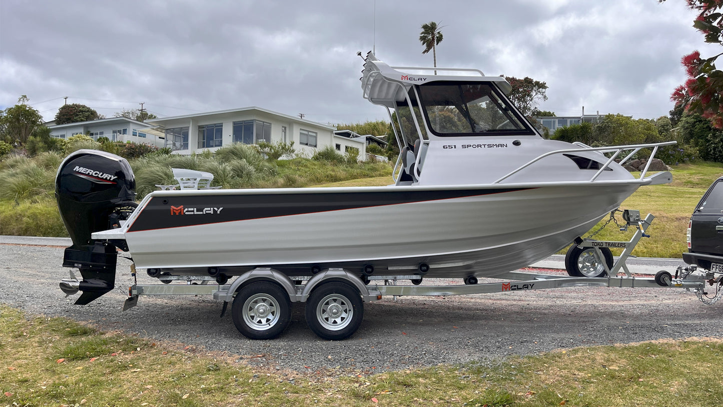McLay 651 Sportsman alloy boat on trailer, featuring hard top and Mercury outboard at Warren Hay Marine. Whangarei