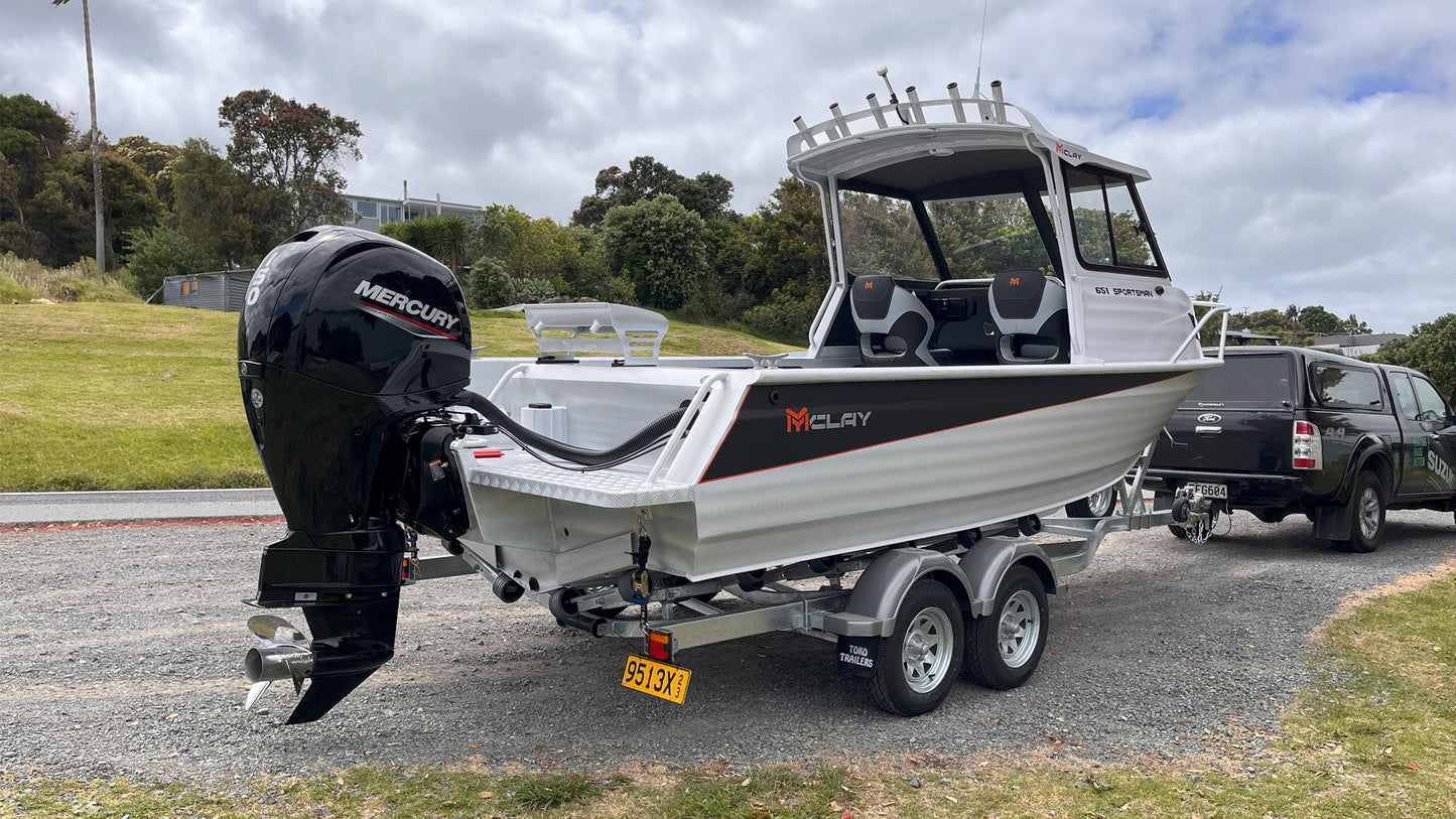 McLay 651 Sportsman alloy boat on trailer, featuring hard top and Mercury outboard at Warren Hay Marine. Whangarei