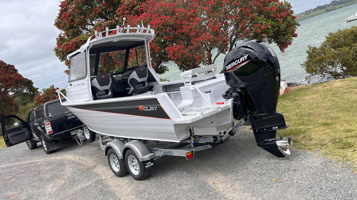 McLay 651 Sportsman alloy boat on trailer, featuring hard top and Mercury outboard at Warren Hay Marine. Whangarei