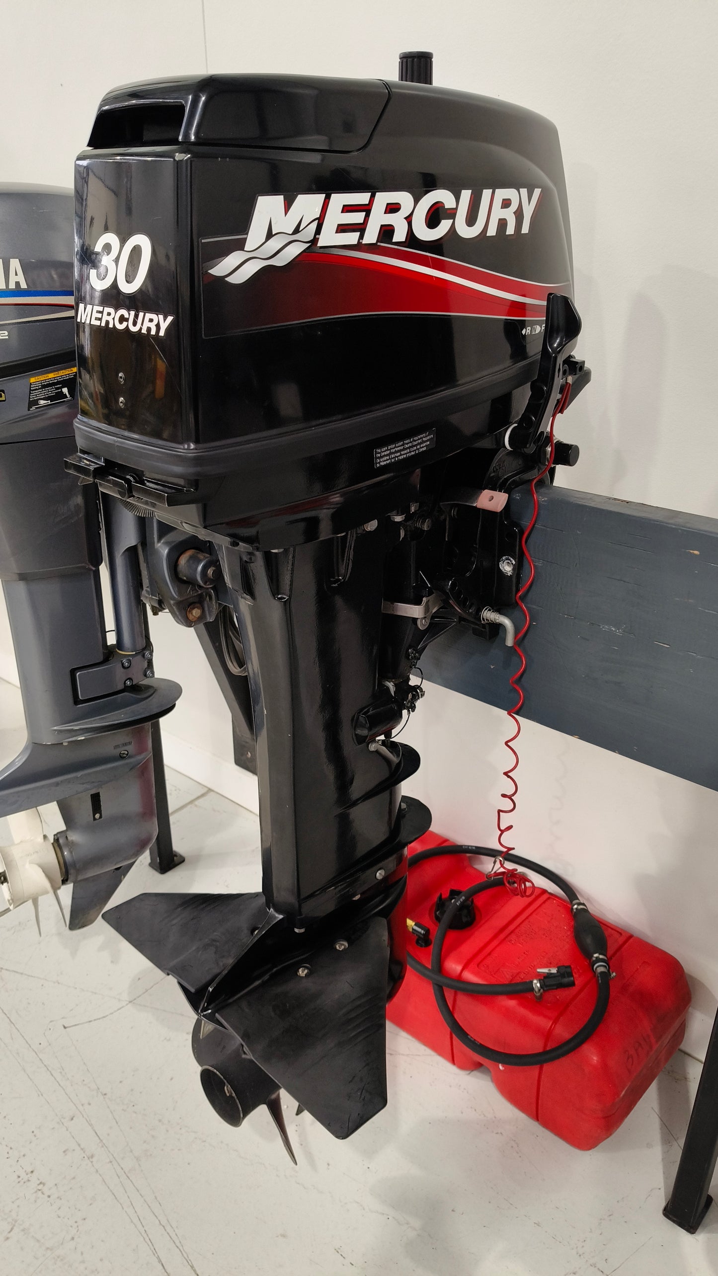 Used Mercury ME30HP 2-stroke tiller steer outboard motor with 20-inch shaft in great condition.