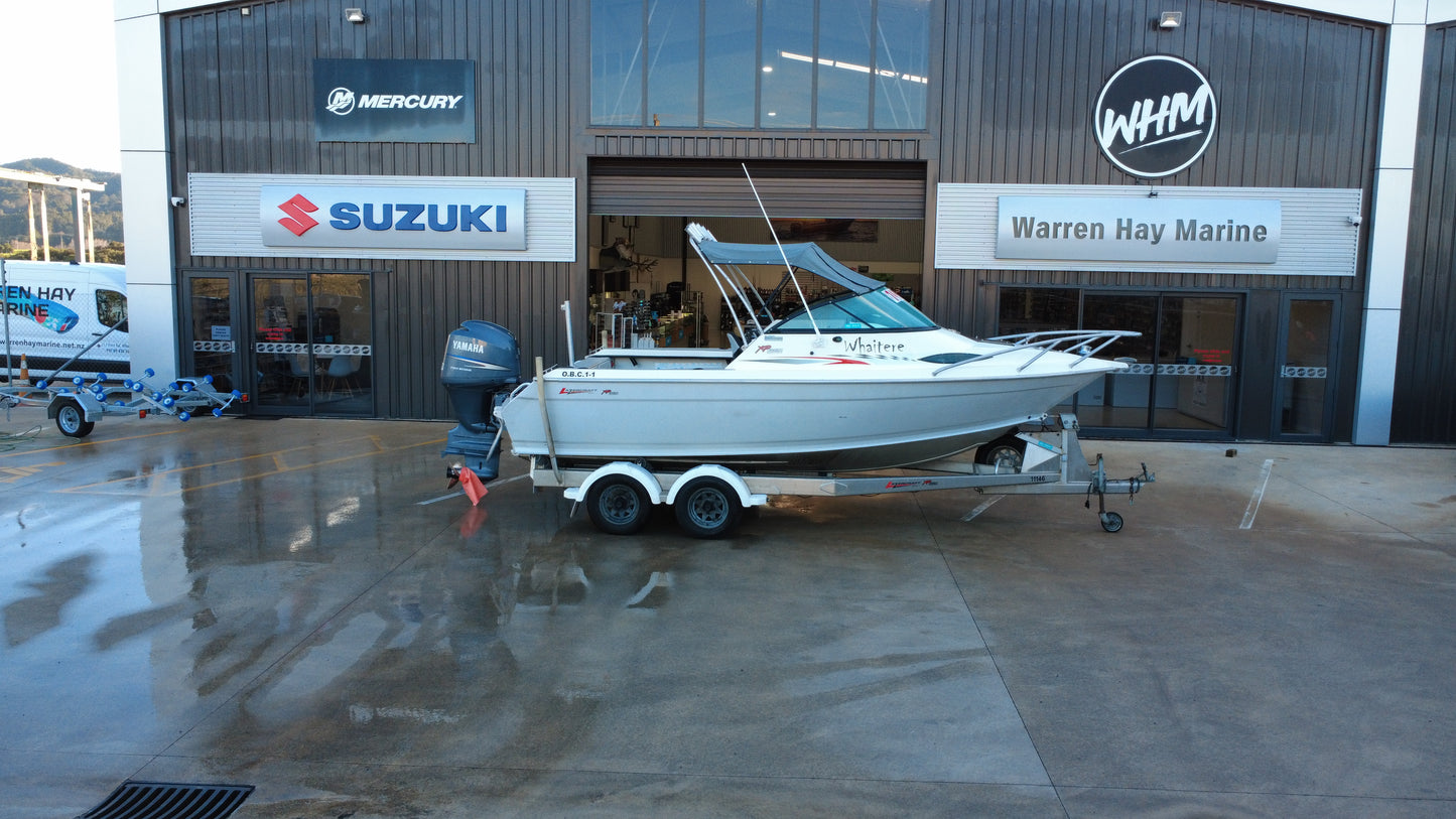 Starboard profile of the Lazercraft 621XP aluminium fishing boat on its tandem axle trailer.