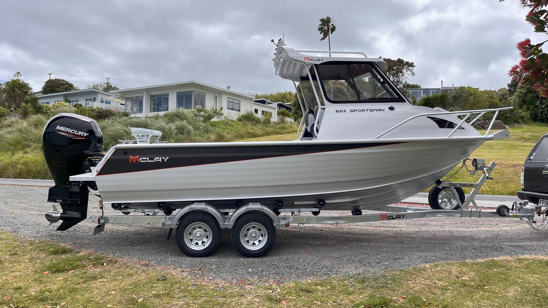 McLay 651 Sportsman alloy boat on trailer, featuring hard top and Mercury outboard at Warren Hay Marine. Whangarei