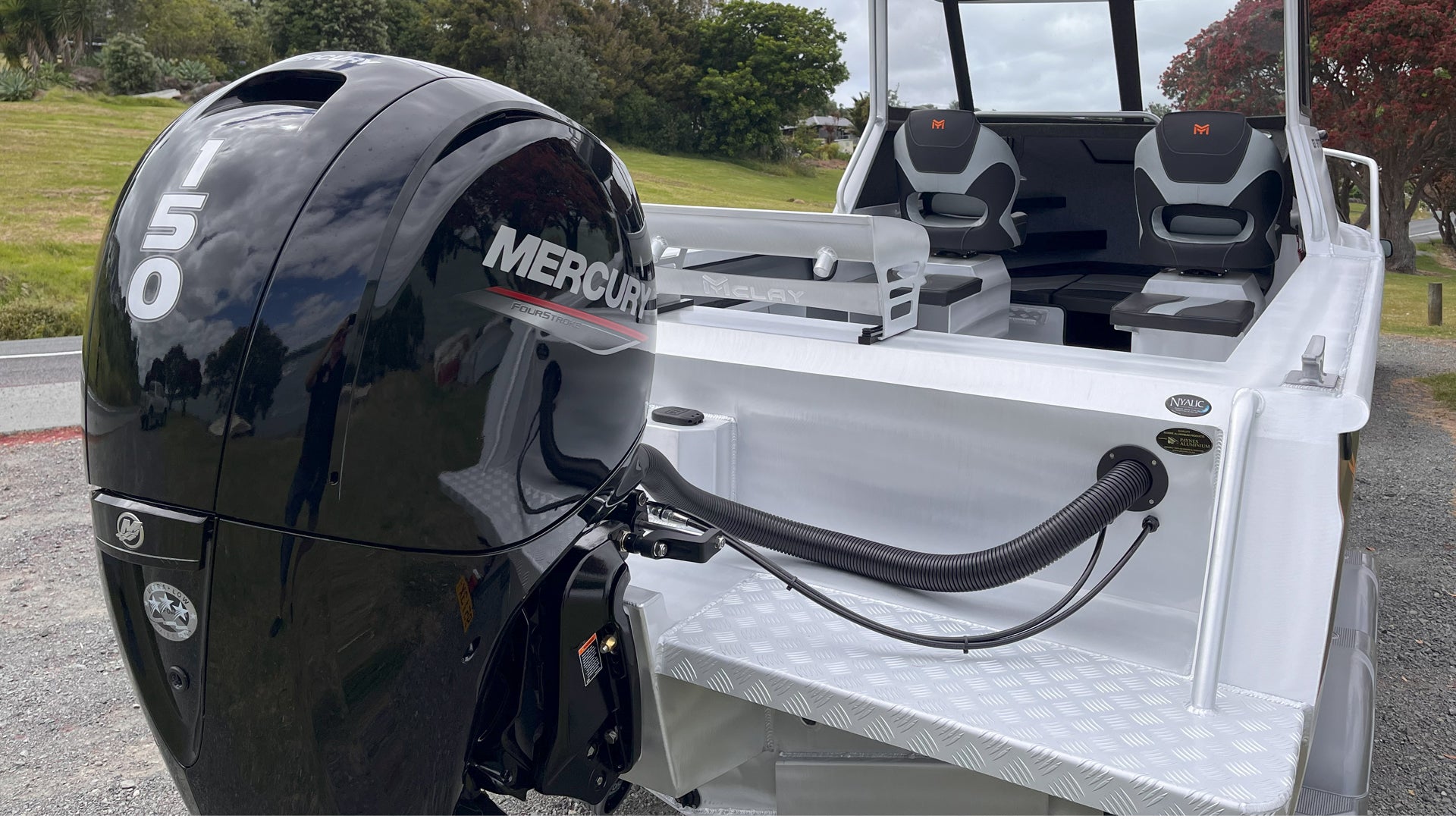 McLay 651 Sportsman alloy boat on trailer, featuring hard top and Mercury outboard at Warren Hay Marine. Whangarei