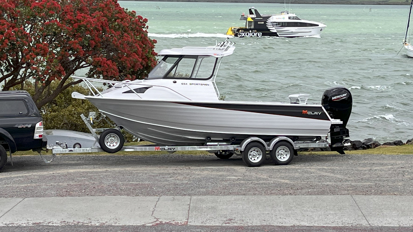 McLay 651 Sportsman alloy boat on trailer, featuring hard top and Yamaha outboard at Warren Hay Marine. Whangarei
