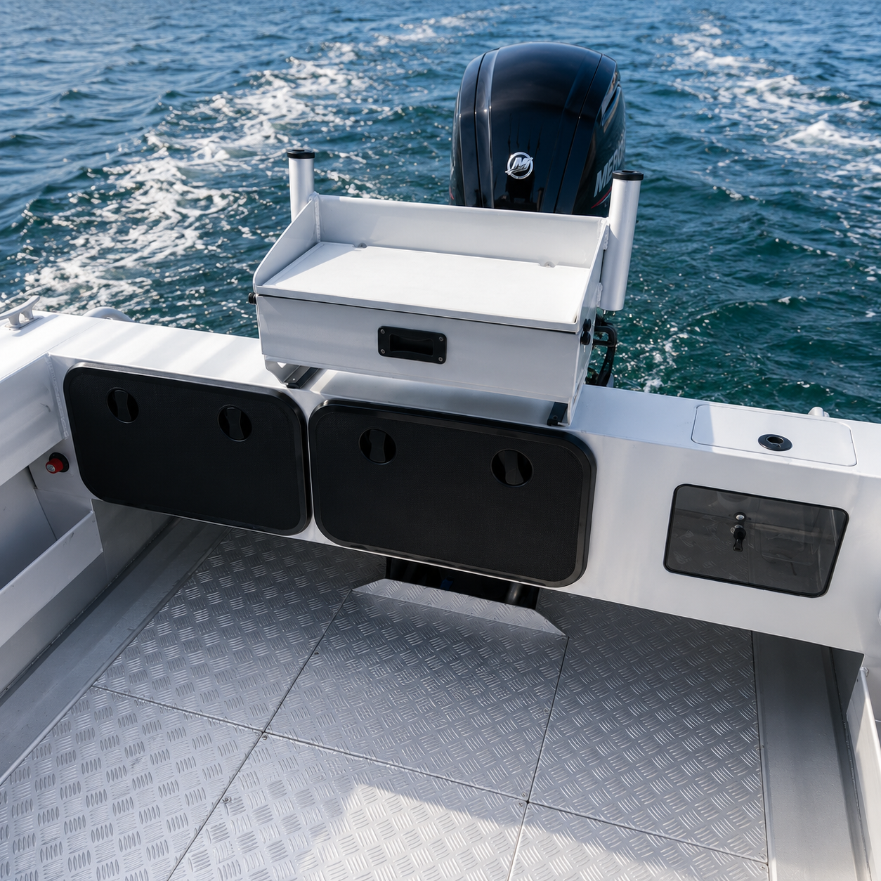McLay Sportsman rear cockpit featuring bait station, transom storage compartments and Mercury outboard engine.