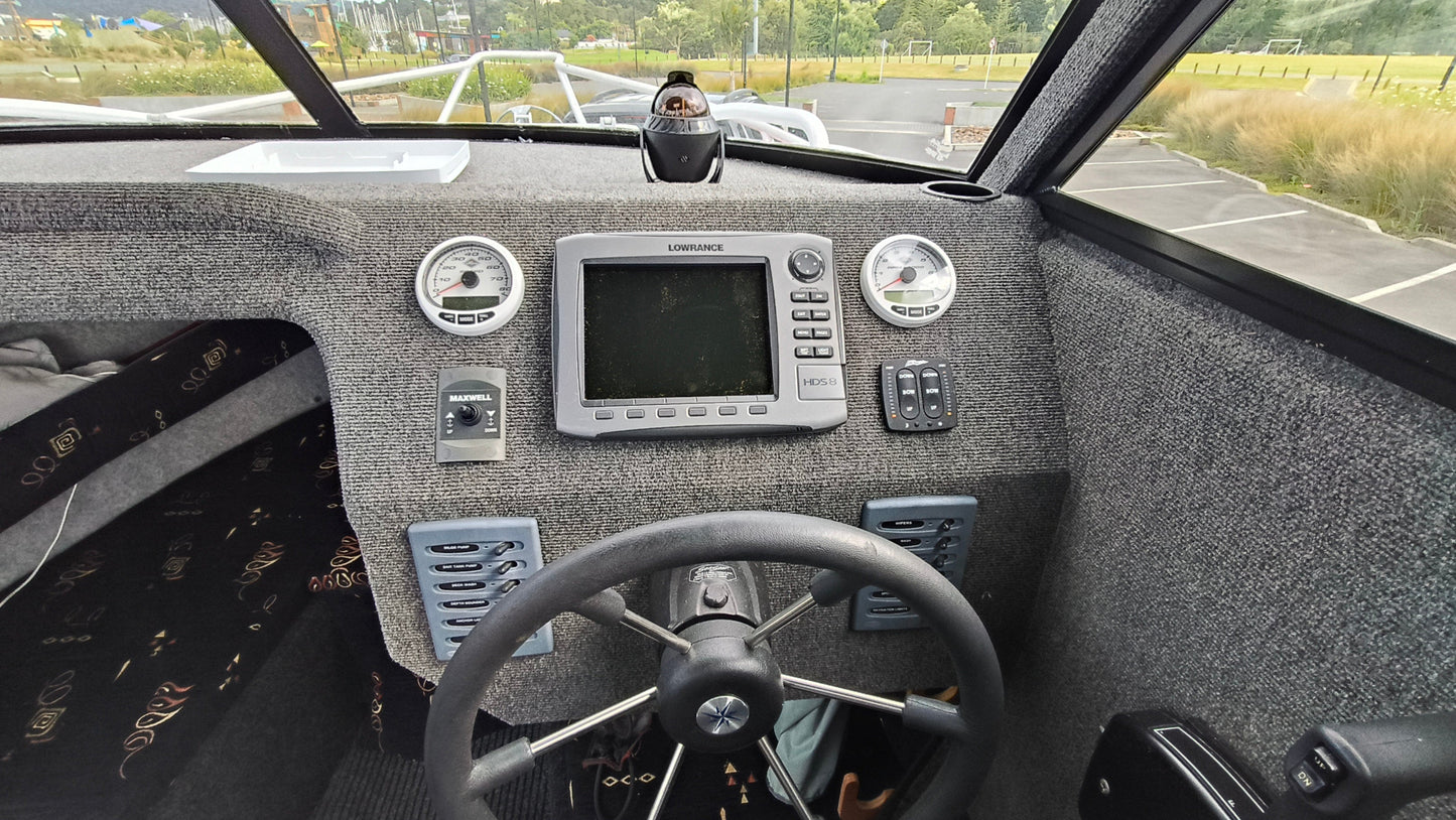 Used 2010 McLay 680 hardtop boat powered by a 225hp Mercury Optimax outboard, sitting on a tandem-axle Toko trailer. Features include boarding ladder, bait board, trim tabs, step mounts, livebait tank, twin batteries with VSR and isolation switch, GME VHF, Lowrance HDS 8, and 170L underfloor fuel tank. Warren Hay Marine, Whangarei