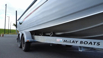 Used 2010 McLay 680 hardtop boat powered by a 225hp Mercury Optimax outboard, sitting on a tandem-axle Toko trailer. Features include boarding ladder, bait board, trim tabs, step mounts, livebait tank, twin batteries with VSR and isolation switch, GME VHF, Lowrance HDS 8, and 170L underfloor fuel tank. Warren Hay Marine, Whangarei