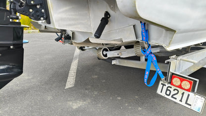 Used 2010 McLay 680 hardtop boat powered by a 225hp Mercury Optimax outboard, sitting on a tandem-axle Toko trailer. Features include boarding ladder, bait board, trim tabs, step mounts, livebait tank, twin batteries with VSR and isolation switch, GME VHF, Lowrance HDS 8, and 170L underfloor fuel tank. Warren Hay Marine, Whangarei