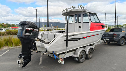 Used 2010 McLay 680 hardtop boat powered by a 225hp Mercury Optimax outboard, sitting on a tandem-axle Toko trailer. Features include boarding ladder, bait board, trim tabs, step mounts, livebait tank, twin batteries with VSR and isolation switch, GME VHF, Lowrance HDS 8, and 170L underfloor fuel tank. Warren Hay Marine, Whangarei