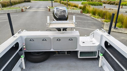 Used 2010 McLay 680 hardtop boat powered by a 225hp Mercury Optimax outboard, sitting on a tandem-axle Toko trailer. Features include boarding ladder, bait board, trim tabs, step mounts, livebait tank, twin batteries with VSR and isolation switch, GME VHF, Lowrance HDS 8, and 170L underfloor fuel tank. Warren Hay Marine, Whangarei