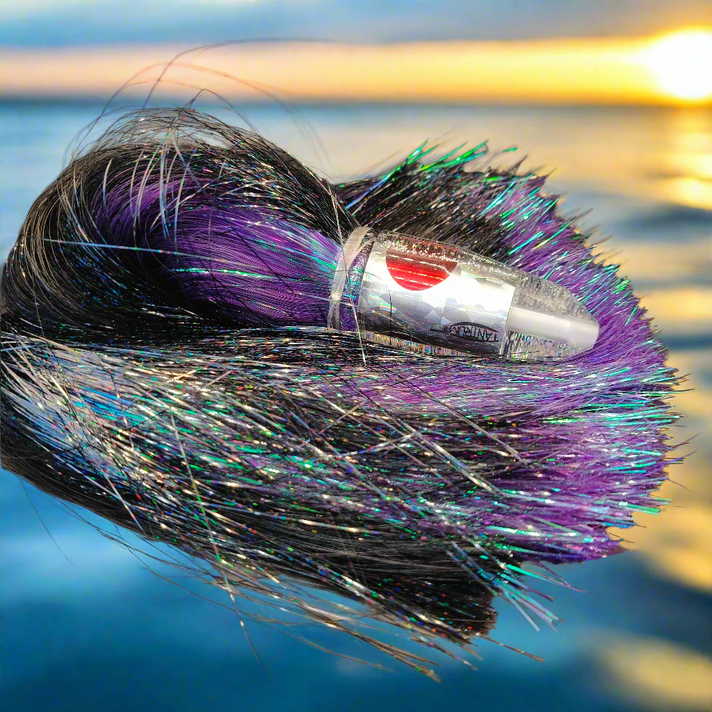 Tantrum Medium Bullet lure with silver/clear head and purple/black Strobez skirts – available at Warren Hay Marine.