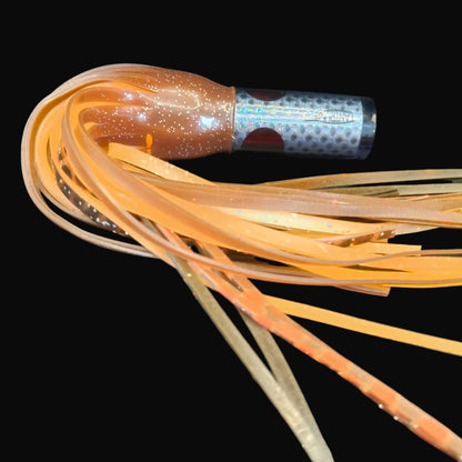 Tantrum Small AMN lure with clear silver head and BlueOcean black/brown over orange skirts, 270mm.