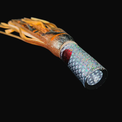 Tantrum Small AMN game lure with black head and Blue Ocean skirts in dark brown over orange brown.