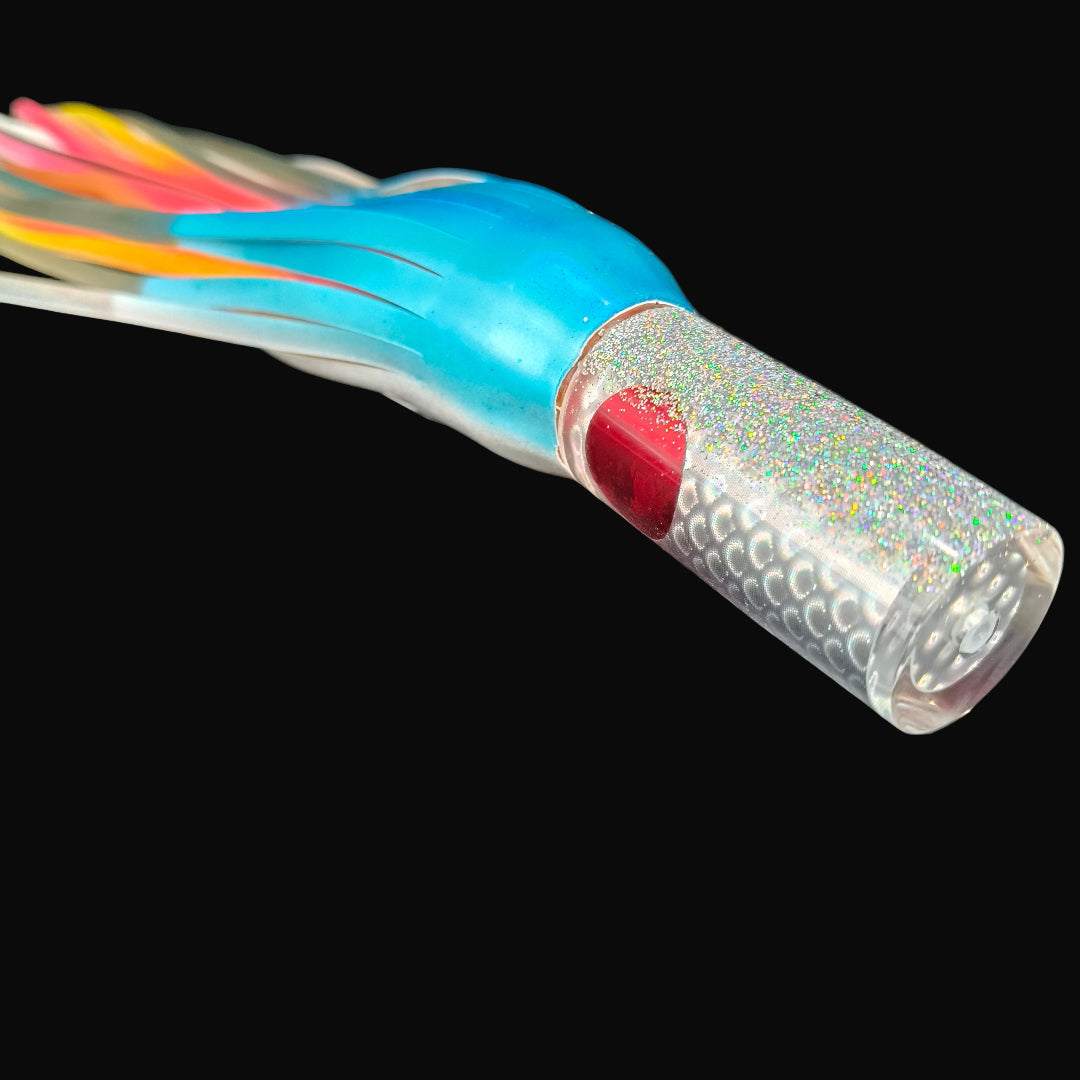 Tantrum Small AMN game lure with clear head and Blue Ocean skirts in blue/silver over orange/pink.