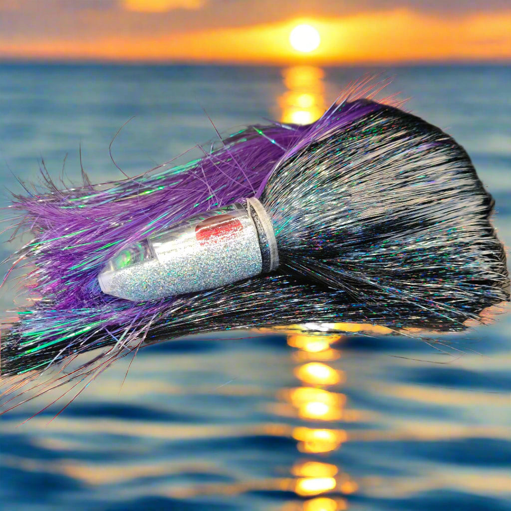 Tantrum Medium Bullet lure with silver/clear head and purple/black Strobez skirts – available at Warren Hay Marine.