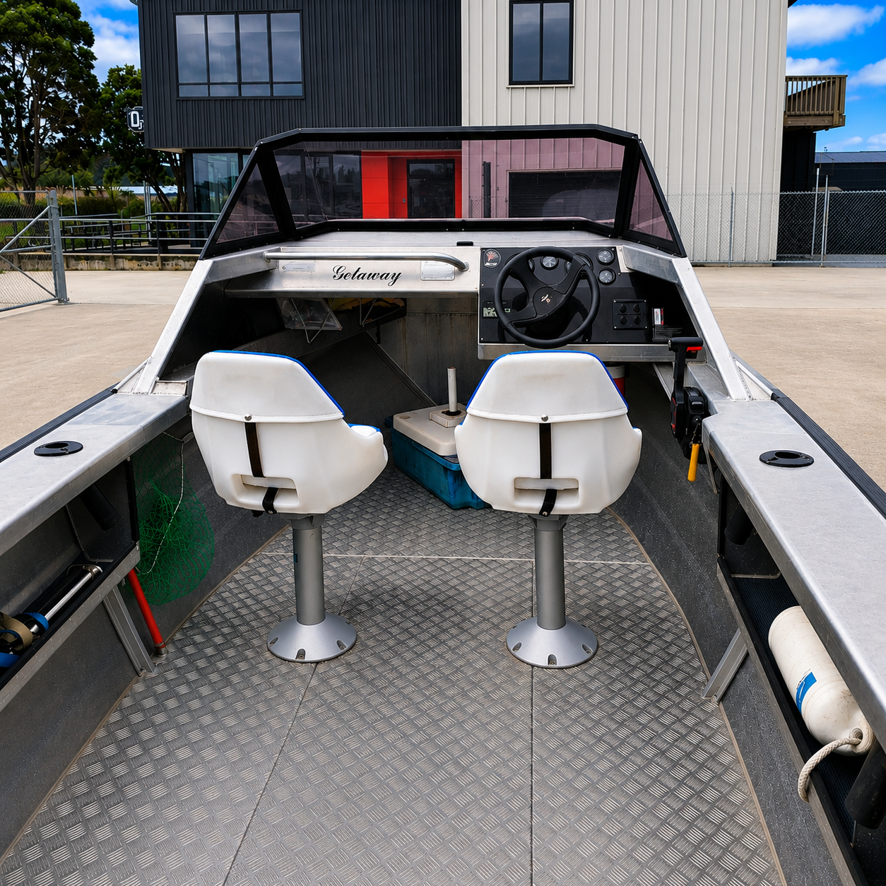 Used Boats, Interior view of the used Ramco Getaway aluminium runabout showing the helm, twin pedestal seats, open cockpit, side storage, and forward cuddy cabin access. Warren Hay Marine, Whangarei