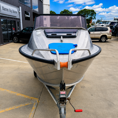 Front view of a used Ramco Getaway aluminium runabout on a Voyager trailer, featuring the bow, anchor roller, windscreen, and open cockpit at Warren Hay Marine, Whangārei.