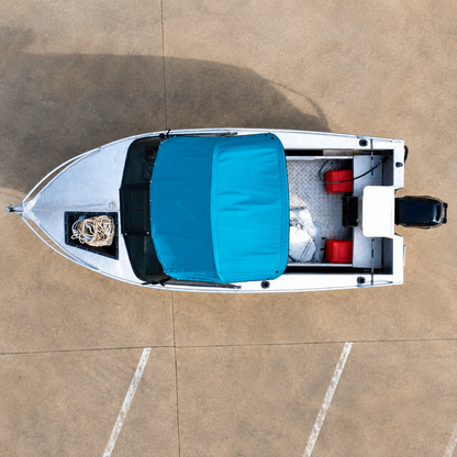 Top-down aerial view of a 2006 Marco 480 Blazer aluminium runabout with Mercury 50hp two-stroke outboard, showing cockpit layout, bimini top and bow storage on trailer. Warren Hay Marine, Whangarei 