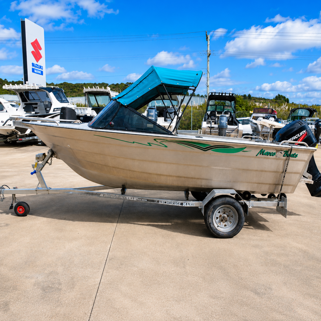 Used Boats, Port side view of a 2006 Marco 480 Blazer aluminium runabout with Mercury 50hp two-stroke outboard on a galvanised trailer at Warren Hay Marine, Whangārei.