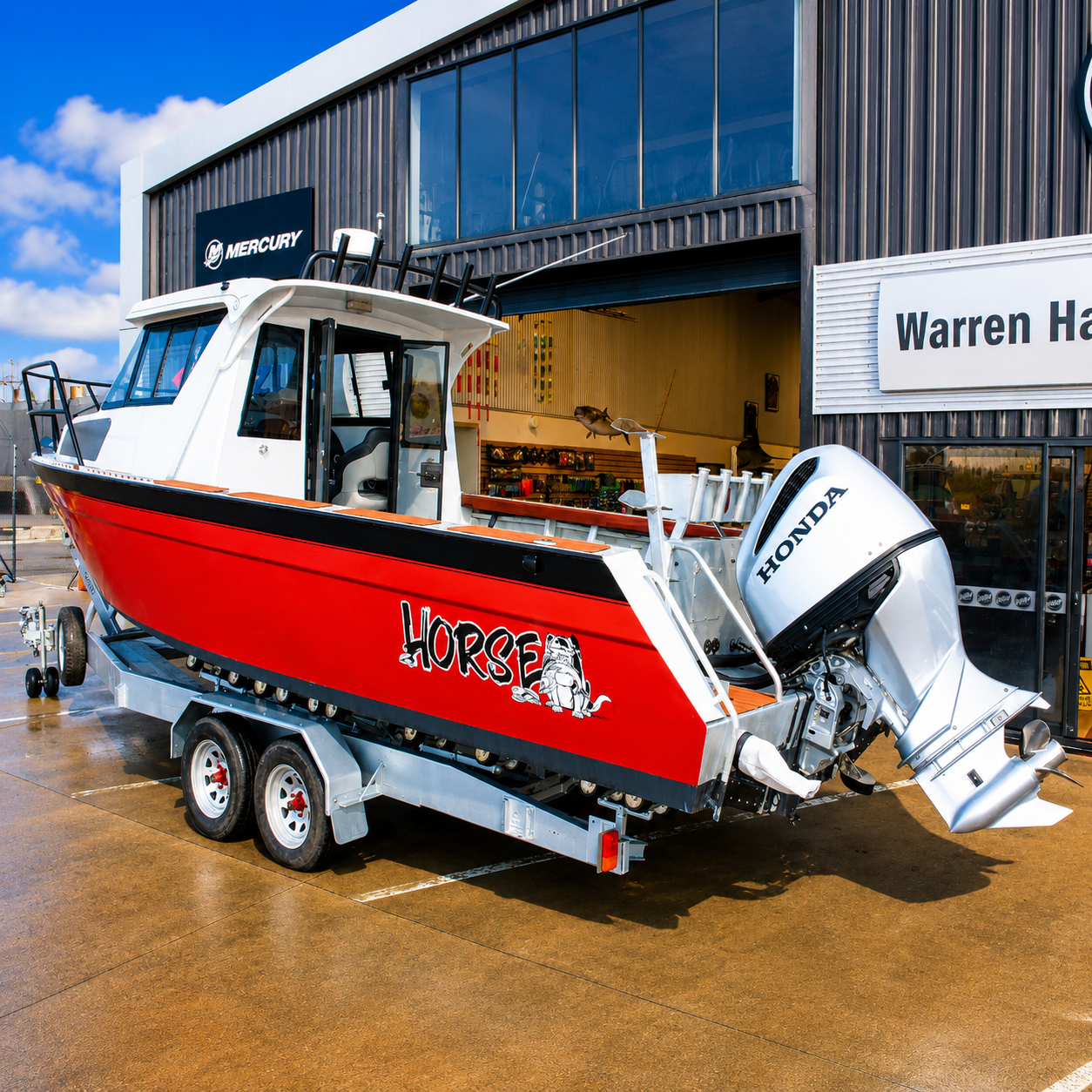 Rear three-quarter view of a used Brave HT 800 aluminium hardtop boat powered by a Honda BF250 outboard, sitting on a galvanised tandem axle trailer outside Warren Hay Marine in Whangārei.