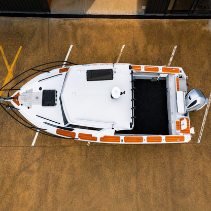 Top-down aerial view of a used Brave HT 800 aluminium hardtop boat, showcasing the walkaround decks, spacious self-draining cockpit, cabin roof, and Honda BF250 outboard on a galvanised tandem axle trailer.