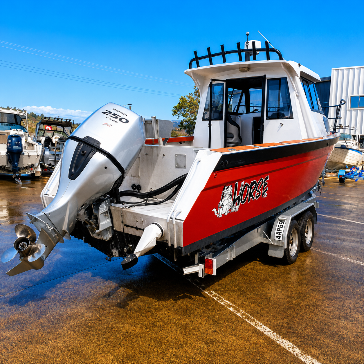 Rear port-side view of a used Brave HT 800 aluminium hardtop boat with Honda BF250 VTEC outboard on a galvanised tandem axle trailer, showcasing the fishing cockpit and transom layout.