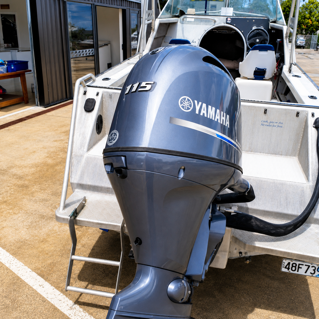 Close-up of the Yamaha F115 FourStroke outboard mounted on the Ramco Fishmaster 580 transom.