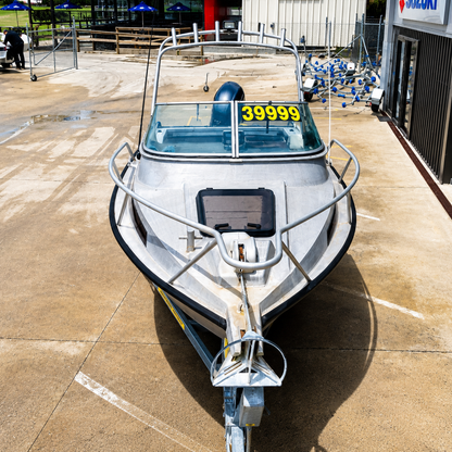 Front view of the Ramco Fishmaster 580 showing the bow, anchor roller, windscreen and trailer setup.
