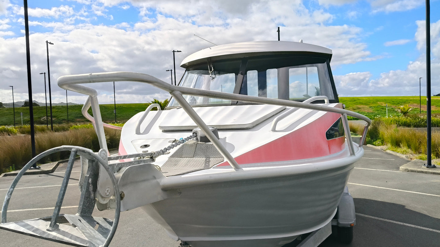 Used 2010 McLay 680 hardtop boat powered by a 225hp Mercury Optimax outboard, sitting on a tandem-axle Toko trailer. Features include boarding ladder, bait board, trim tabs, step mounts, livebait tank, twin batteries with VSR and isolation switch, GME VHF, Lowrance HDS 8, and 170L underfloor fuel tank. Warren Hay Marine, Whangarei
