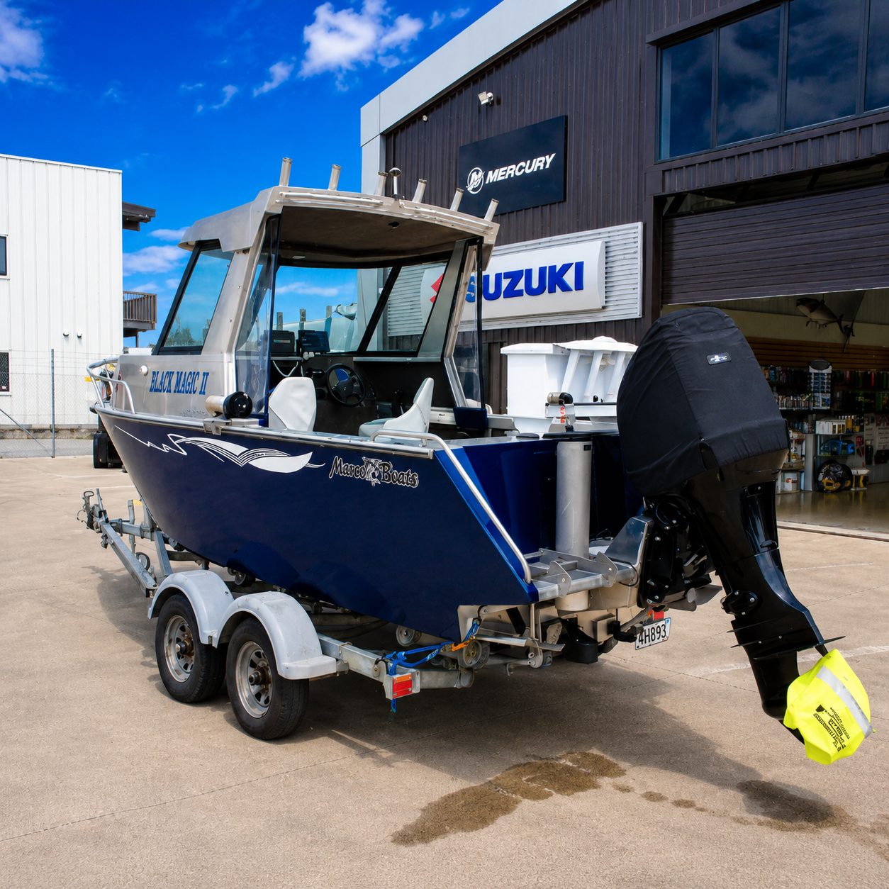 Used Boat, Rear starboard view of a 2018 Marco 600 Sou'Wester Hard Top with Suzuki BF140 four-stroke outboard on an Ultra Trailers tandem axle trailer, showcasing the fishing cockpit, transom, and hardtop at Warren Hay Marine, Whangārei. 
